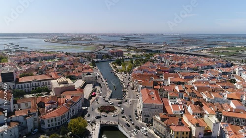 Aerial View City Center of Aveiro Portugal 4k. Aveiro aerial cityscape. Tourists enjoying tour on moliceiros, tradition boats of Ria de Aveiro. Venice of Portugal. Travel Destination.