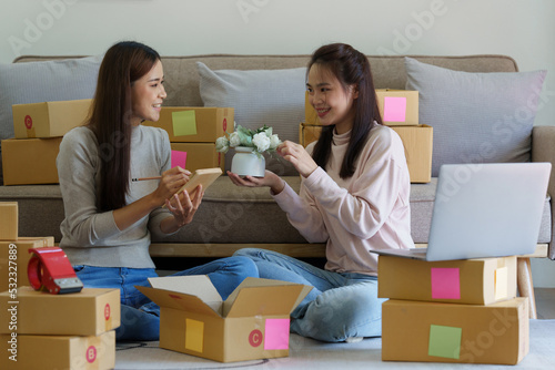 Asian SME business woman with partner working at home office. online shopping concept © itchaznong