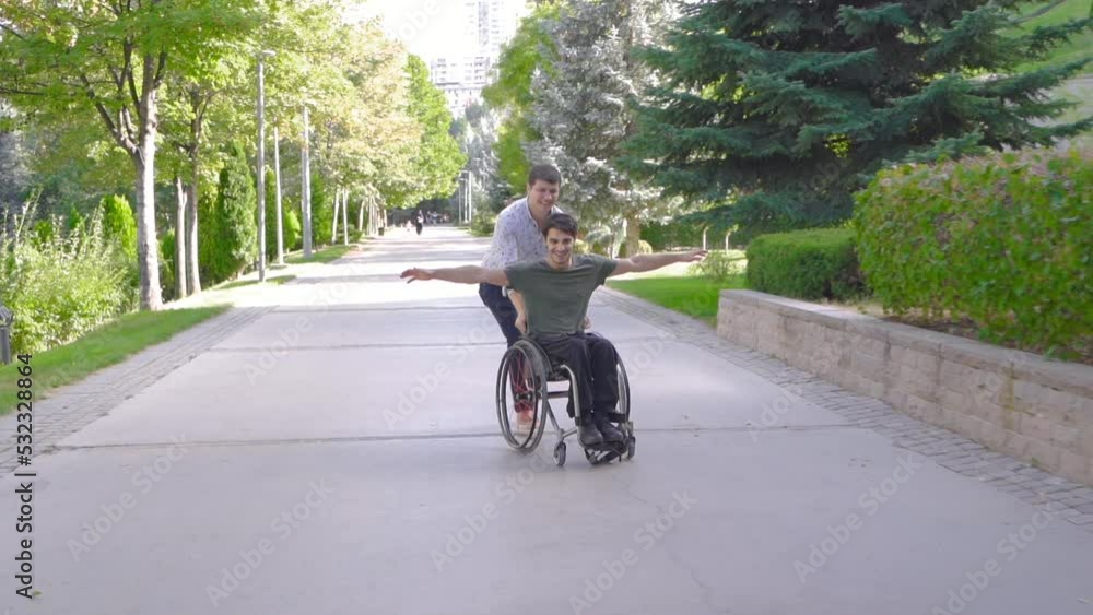 A physically disabled young man is walking with his friend outdoors.
Disabled young man and his friend are having fun and happy.
A physically disabled young man is walking with his friend outdoors.
Disabled young man and his friend are having fun and happy.