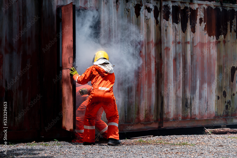 Group firefighters men wearing firefighting suit on safety rescue duty help stop breathing heart attack man inside burning emergency CPR. safety accident protection safety concept.