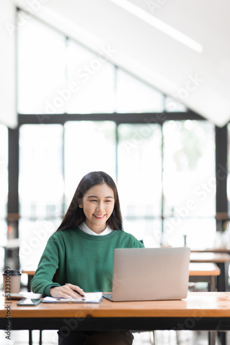 Free Download Young adult happy smiling Hispanic Asian student talking on online chat meeting using laptop in university campus or at virtual office. College female student learning remotely. - GFXLoad