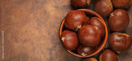 Photography Chestnuts in a bowl  on a wooden background