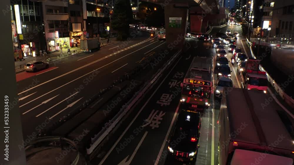 SHIBUYA, TOKYO, JAPAN : Aerial high angle view of street traffic (junction) at night. Many cars at the busy road. Time lapse shot. Japanese transportation concept video. SHIBUYA, TOKYO, JAPAN : Aerial high angle view of street traffic (junction) at night. Many cars at the busy road. Time lapse shot. Japanese transportation concept video.
