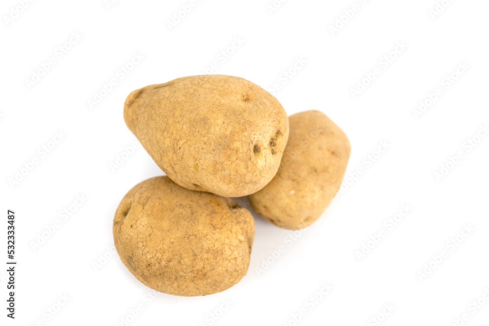 Three fresh potatoes isolated on a white background. Three fresh potatoes isolated on a white background.