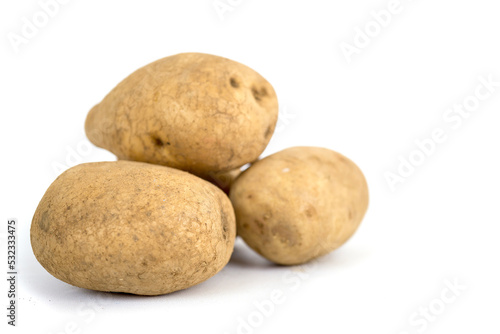 Three fresh potatoes isolated on a white background.