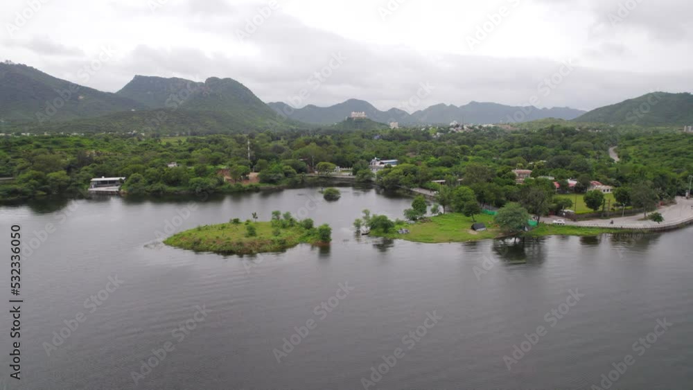 Drone flying over Fateh Sagar lake and Sajjangarh Monsoon palace in background. Tropical landscape in India. 4K Drone flying over Fateh Sagar lake and Sajjangarh Monsoon palace in background. Tropical landscape in India. 4K