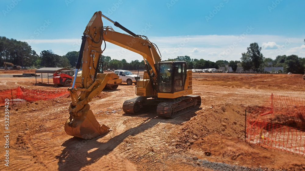 excavator in foreground with dozer and truck on grading site - obrazy, fototapety, plakaty 