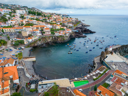 Fototapeta Naklejka Na Ścianę i Meble -  Madeira. Camara de Lobos Aerial View. Small fisherman village with many small boats in a bay. Madeira Island, Portugal.