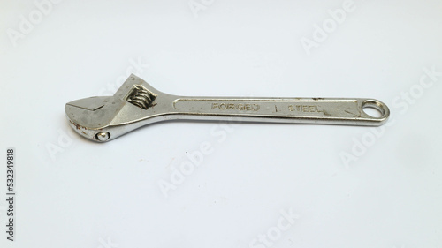 Old adjustable wrench isolated over white © LookmanHakim