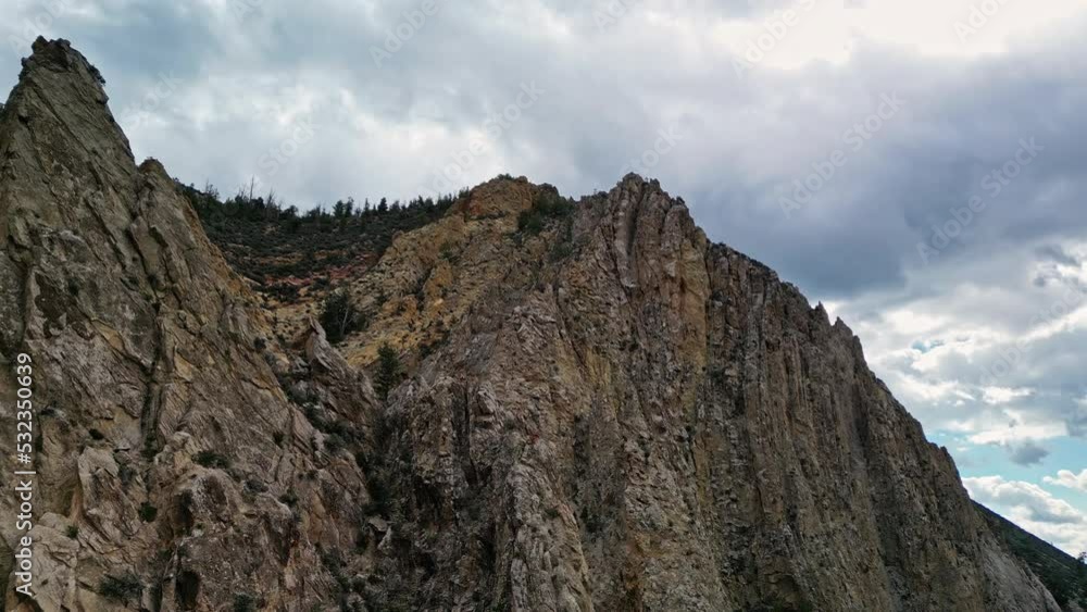 Flying along cliffs as falcon flys by at the Windy Ridge near Flaming Gorge Flying along cliffs as falcon flys by at the Windy Ridge near Flaming Gorge