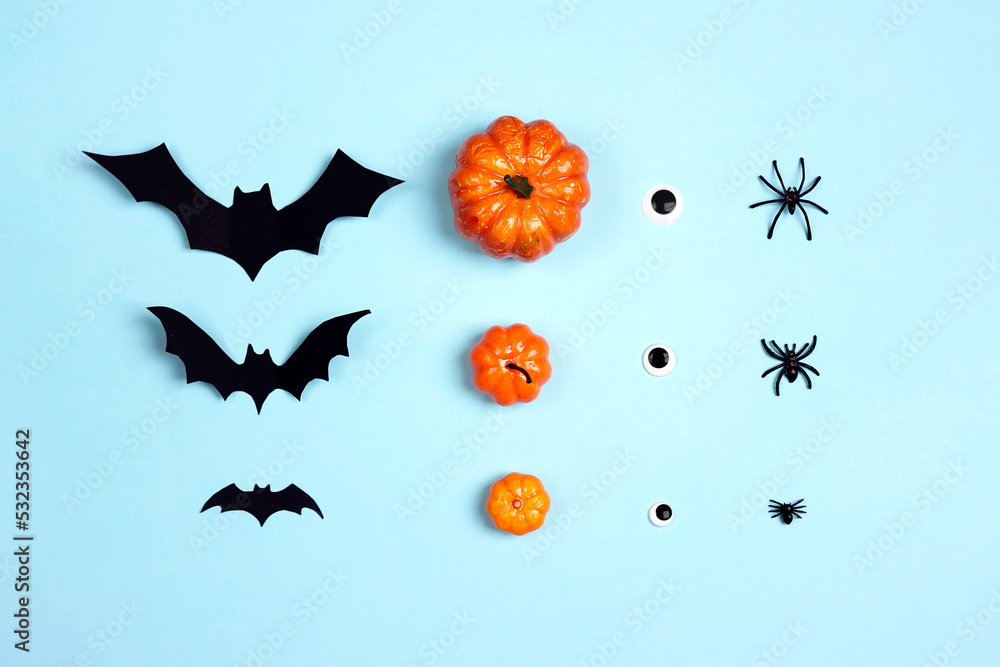Halloween set of big and small bats, pumpkins, eyes and spiders on a blue background. Halloween set of big and small bats, pumpkins, eyes and spiders on a blue background.