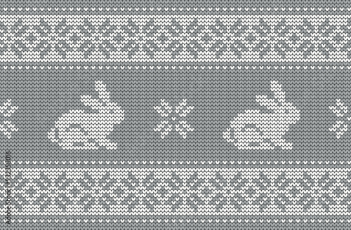 Knitted pattern with rabbits on a gray background. Christmas background. Seamless border. 2023 Year of the Rabbit. Vector illustration