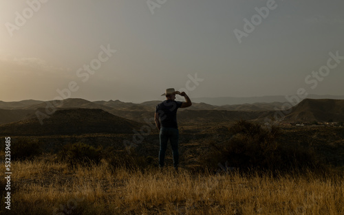 Silhouette of adult man standing on desert during sunset. Almeria, Spain