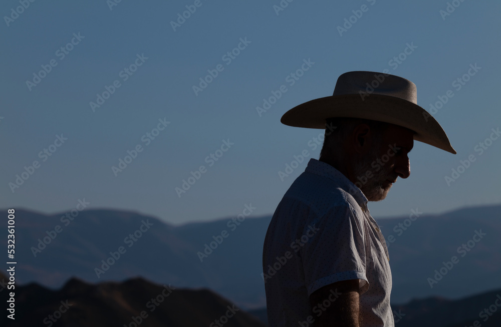 Side view of adult man in cowboy hat in desert. Almeria, Spain