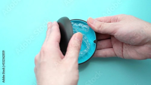 Open the case containing the orthodontic clear aligners for teeth. slow motion video.