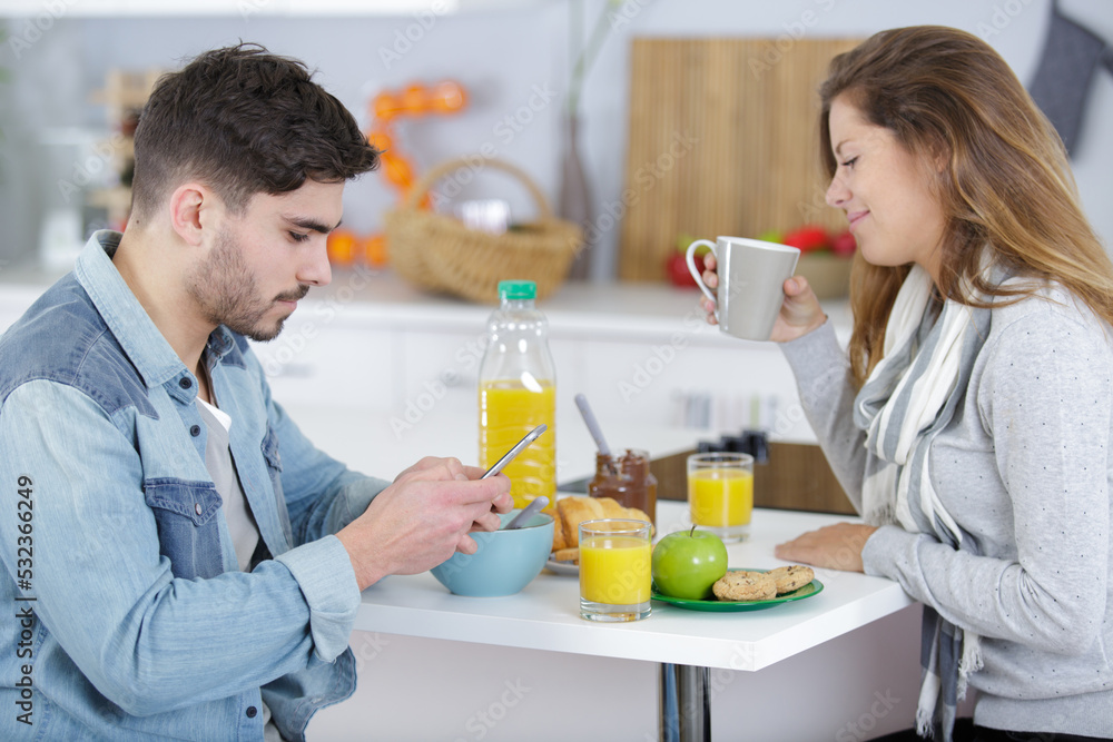 happy couple enjoying breakfast together at home happy couple enjoying breakfast together at home