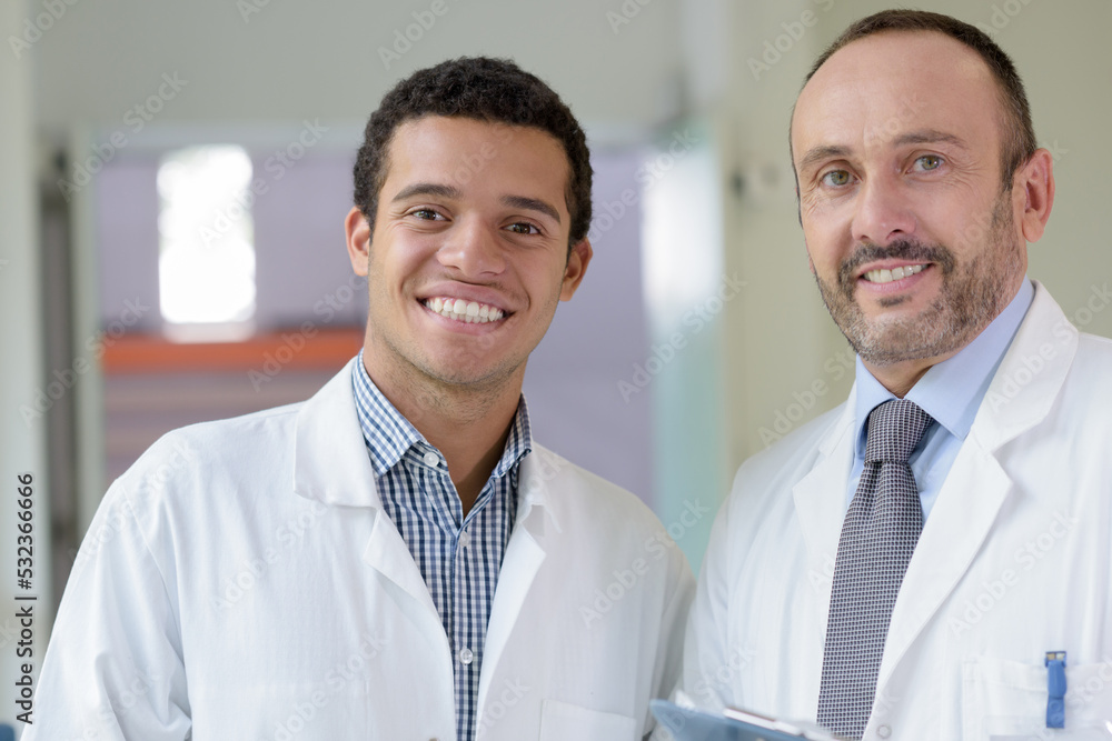 men in white coat smiling men in white coat smiling