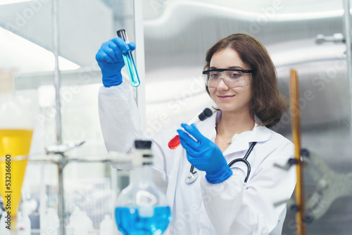 Medical scientists working with scientific equipment in the laboratory. Female scientist doing analysis liquid in glassware tube in the lab office