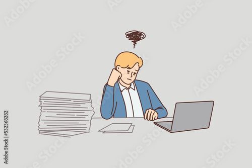 Distressed businessman overwhelmed with office work 