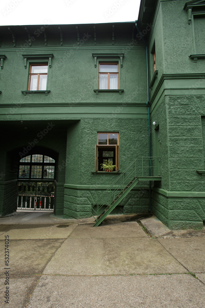dark green beautiful building with small windows and stairs
dark green beautiful building with small windows and stairs