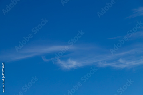 Blue sky with a few clouds background.