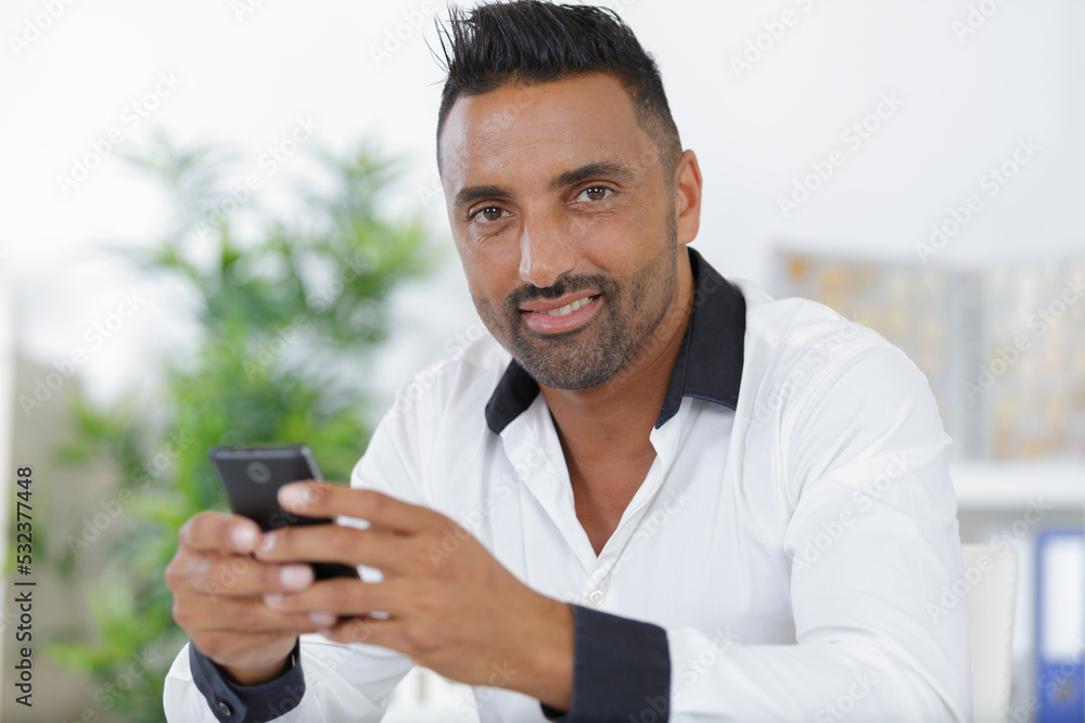 man in office wear using a phone indoors man in office wear using a phone indoors