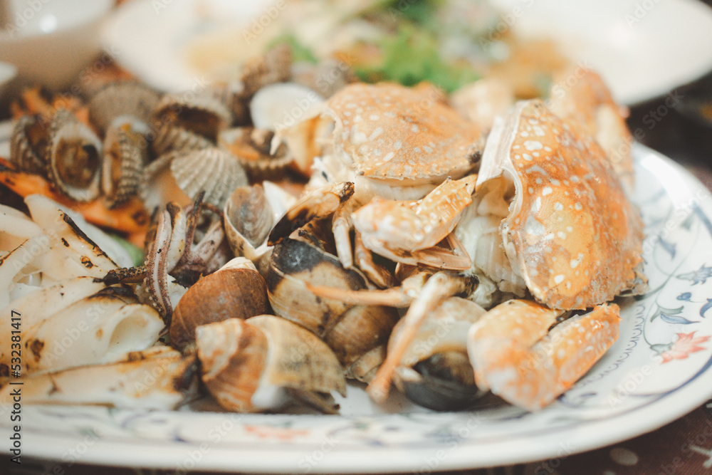 Grilled seafood set include cockle, crab, shrimp, squid and Spotted babylon. Close up Grilled seafood set include cockle, crab, shrimp, squid and Spotted babylon. Close up
