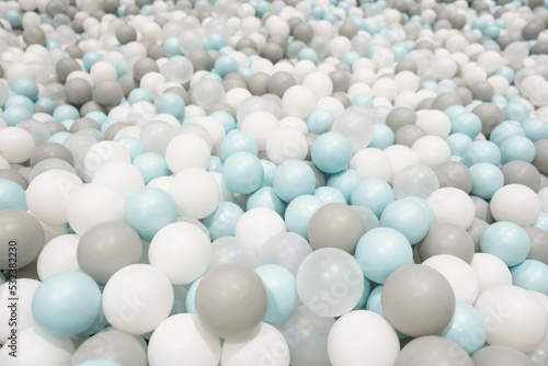 Kid s playing room interior. Colorful white  grey  blue plastic balls background for baby activity. Copyspace