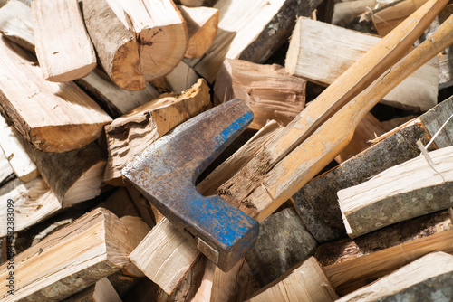 Hatchet Ax and Pile of Split Wood Logs for Fire,