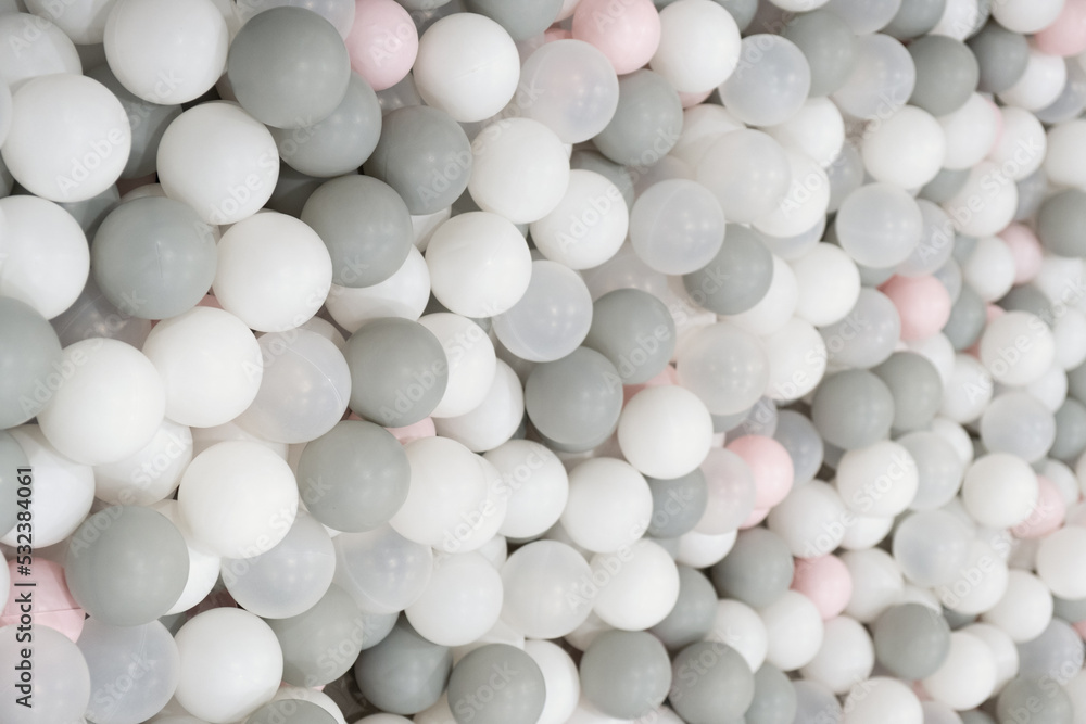 Pastel color white, grey, blue plastic balls background for baby activity. Kid's playing room interior. Copyspace Pastel color white, grey, blue plastic balls background for baby activity. Kid's playing room interior. Copyspace