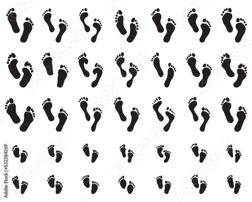 Black prints of human and children feet on a white background	