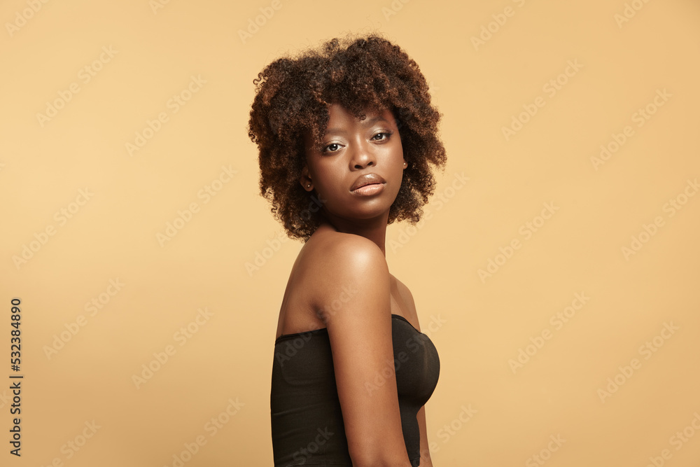 African american calm woman portrait with curly short hair. African american calm woman portrait with curly short hair.