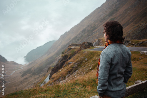 Slika na platnu man stands on road in mountains in Romania, Carpathians