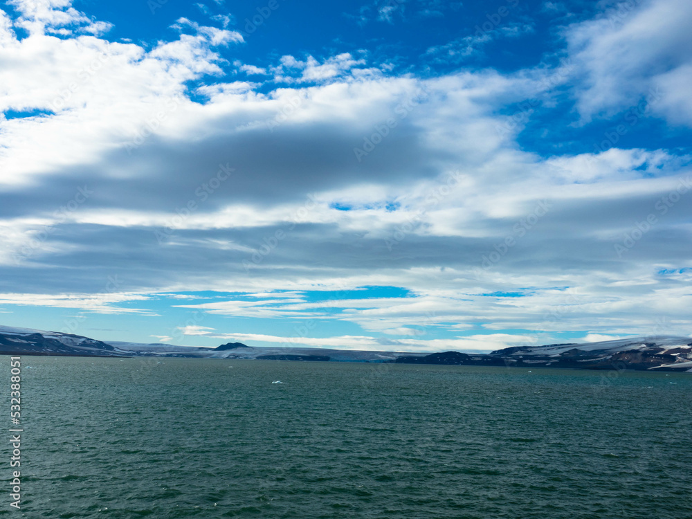 Spectacular panorama view of Wilhelmoya island with mountain range and blue sky. Torellneset, Nordaustlandet
Spitsbergen, Norway. Tourism and vacations concept. Spectacular panorama view of Wilhelmoya island with mountain range and blue sky. Torellneset, Nordaustlandet
Spitsbergen, Norway. Tourism and vacations concept.