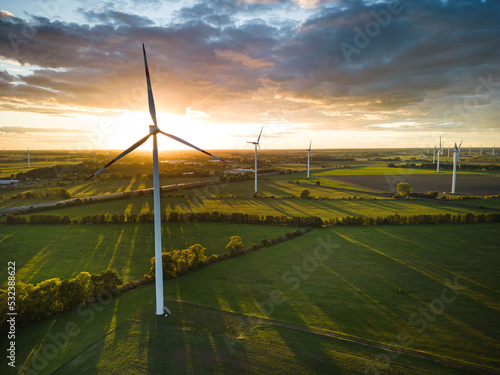 Aerial View of Windturbine against sunset with moody golden lighting