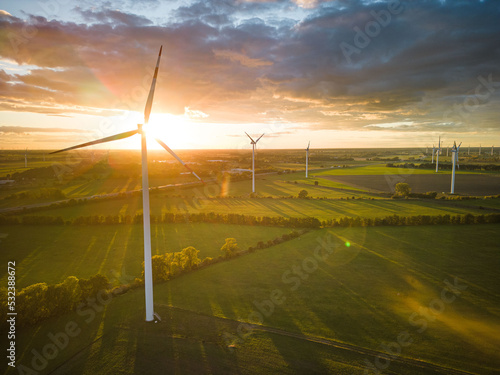 Aerial View of Windturbine against sunset with moody golden lighting photo