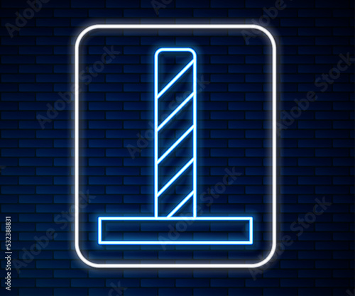 Glowing neon line Cat scratching post with toy icon isolated on brick wall background. Vector