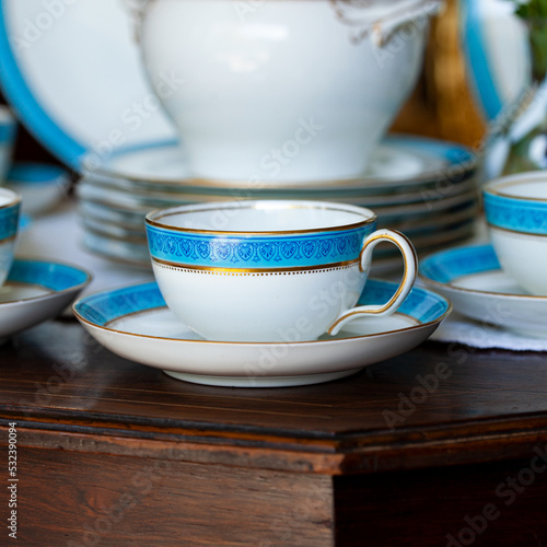 Fototapeta Naklejka Na Ścianę i Meble -  Antique British blue porcelain tea set. wedding table setting is richly decorated in luxurious interior. porcelain vintage service
