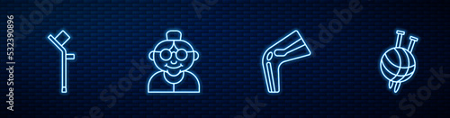 Set line Bone pain, Crutch or crutches, Grandmother and Yarn ball with knitting needles. Glowing neon icon on brick wall. Vector