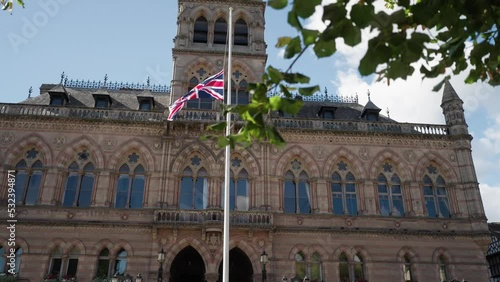 Union flag flying at half mast for the death of Queen Elizabeth II outside Chester city hall. Slow motion cinematic shot. photo