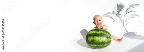 Funny toddler boy playing with watermelon, healthy fruit snack on white background, hot summer day. Organic vegan healthy diet, feeding, solid food concept. Cute baby, child, kid emotins. Copy space