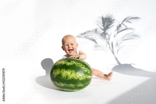 Cute baby, child, kid emotins. Funny toddler boy playing with watermelon, healthy fruit snack on white background, hot summer day. Organic vegan healthy diet, feeding, solid food concept. Copy space