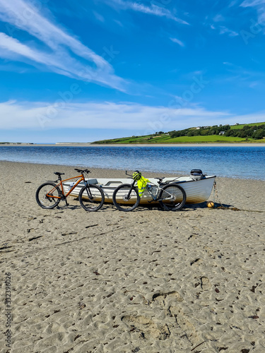 Concept of enjoying the outdoors by bicycle and boat at Gweebarra Bay , County Donegal - Ireland