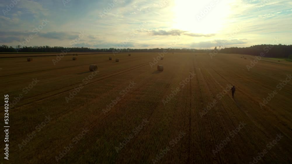 A drone shot of a vast land with shinny yellow sky in the background in morning time A drone shot of a vast land with shinny yellow sky in the background in morning time