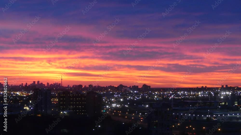 Dramatic night sky illuminated by the vibrant golden colors of the setting sun while slowly panning across the amazing cityscape of Toronto Dramatic night sky illuminated by the vibrant golden colors of the setting sun while slowly panning across the amazing cityscape of Toronto
