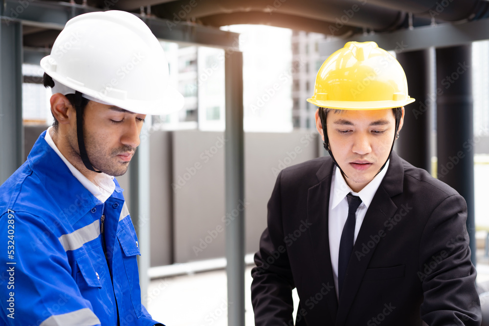 Professional Asian foreman and construction manager talking - discussing about building structure plant together. Professional Asian foreman and construction manager talking - discussing about building structure plant together.