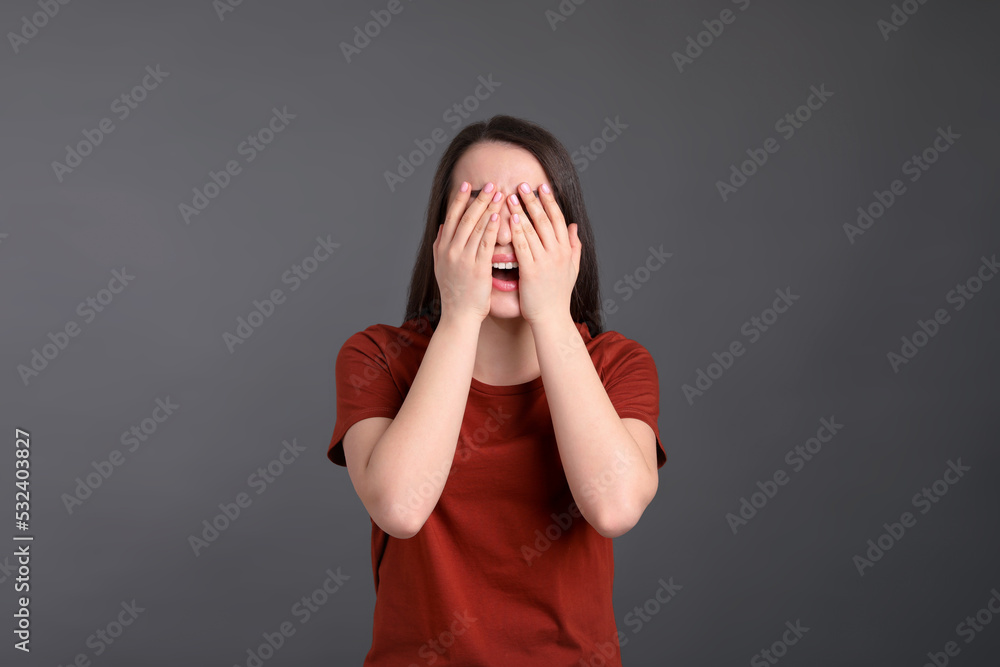 Emotional young woman on dark grey background. Personality concept Emotional young woman on dark grey background. Personality concept