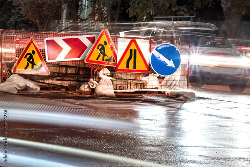 Road closure and diversion signs. Roadworks in night city street photo