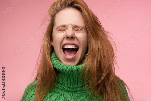 Ginger woman screaming with closed eyes