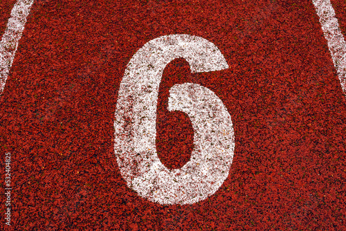 The number 6 at start point of running track or athlete track in stadium photo
